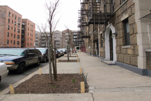 Eine spärliche Stadtansicht mit wenigen Autos und Gebäuden in der rechten Ecke und einigen anderen Gebäuden in der linken Ecke.